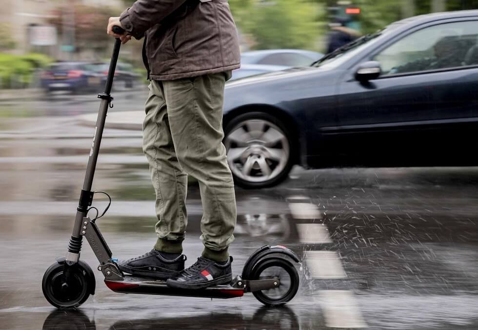 Man riding the Segway Max in wet road conditions