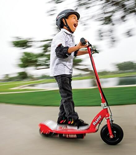 Lad riding his scooter flat out.