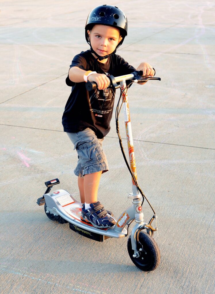 Young boy riding his new escooter.