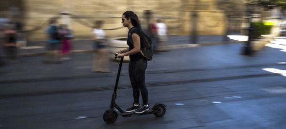 woman riding a pro-scooter in the streets of Seville 