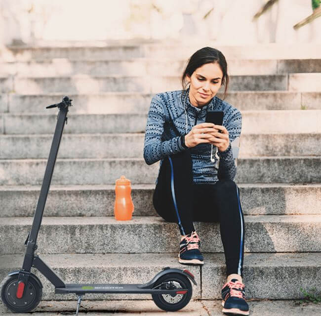 women sat on a step next to her power scooter